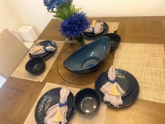 Glass table set up plates bowls napkin holders