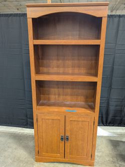 Sturdy Reddish-Brown Wood Bookcase with Arched Top and Cabinet