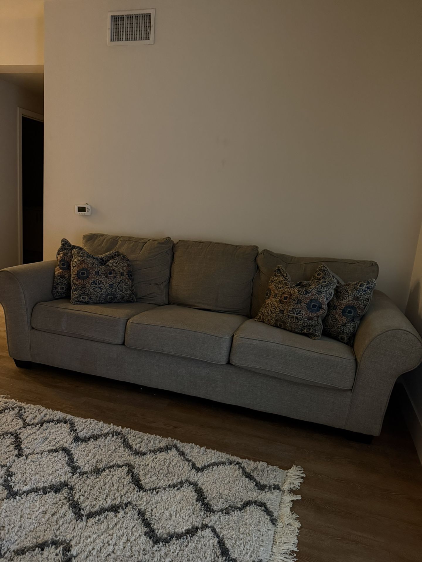 3-seater beige sofa with accent pillows