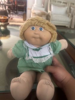 Blond cabbage patch doll with green dress