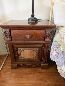 Ornate wood nightstand.