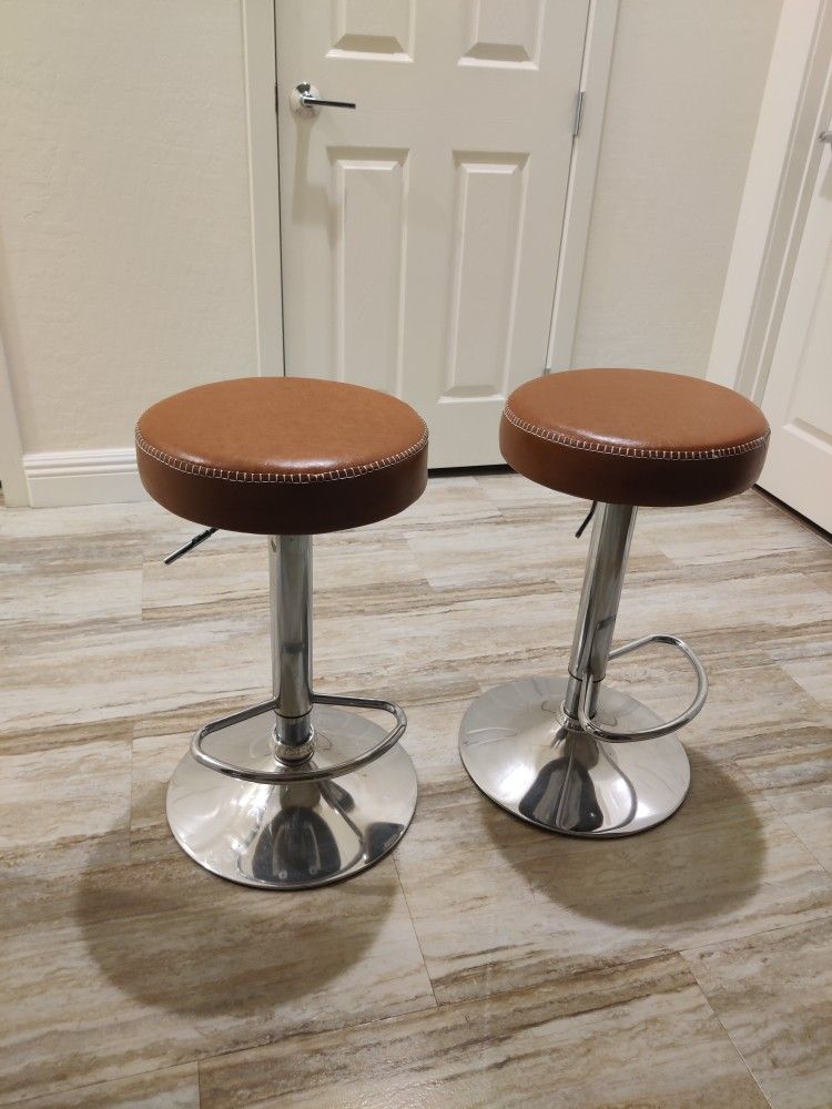 Two Caramel Colored Adjustable Bar Stools