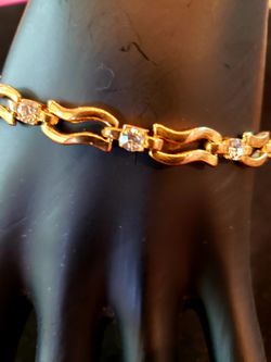 $10. Beautiful 14k gold plated CZ bracelet. 7.5 inches long and 3/16 inch wide. 8 CZs. No fading.