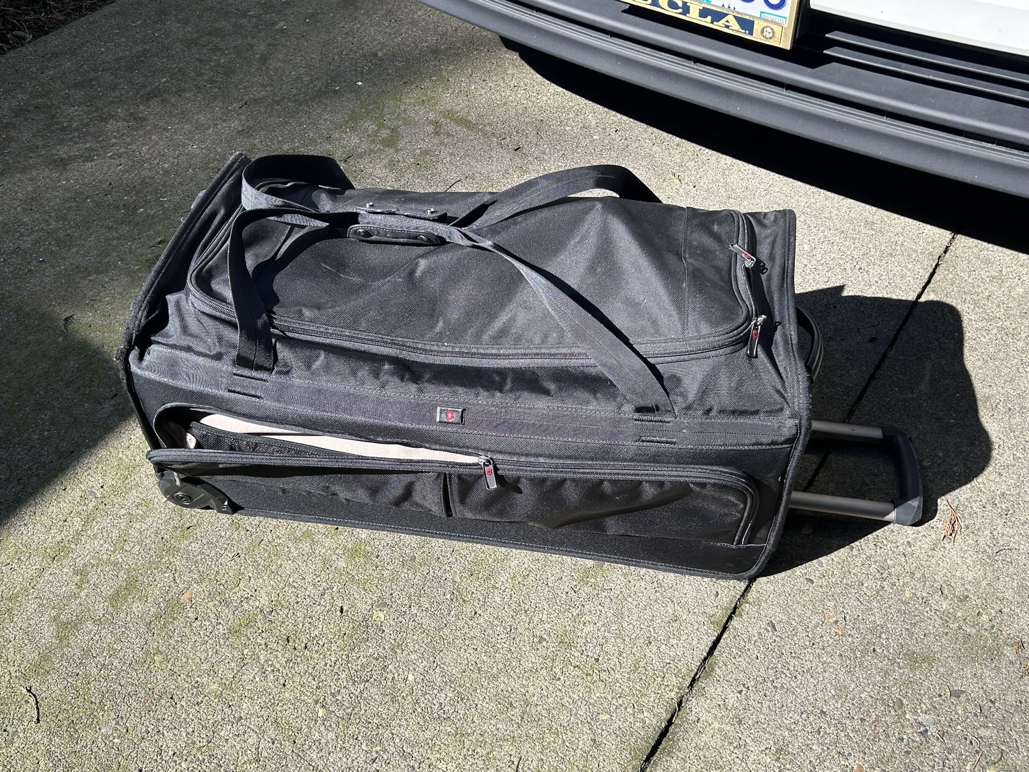 Victorinox Luggage. Black:  15” W x 32” L. x  14” depth  on rollers 