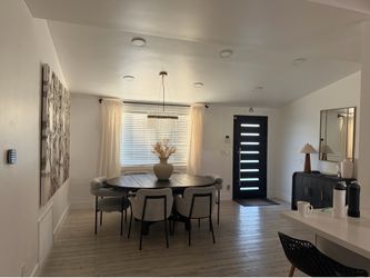 Oval black wood dining table and Cb2 dining chairs