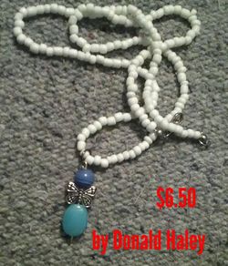 White necklace with a little butterfly charm