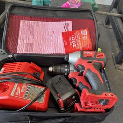 milwalukee M18 combo kit with one M18 drill, one M12 drill, M12 & M18 dual charger, one red lithium battery, & soft outer case