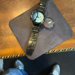 Invicta compus watch with black leather strap.