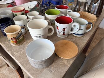 Coffee cups tea pots and a fruit rack