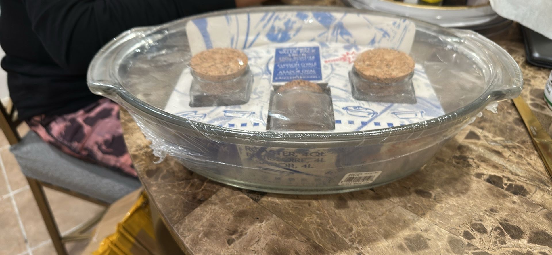 The product is an Anchor Hocking Oven Basics 4-Quart Oval Roaster. It is a glass baking dish that comes with three bonus spice jars.