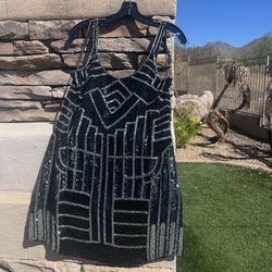 Black and silver sequence dress by Parker women’s size small. 100% silk/lining rayon . Has back sipper. Measures 32” inches in length and 27” across t