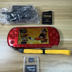 Red PSP 3000 Console with 100 games installed.        G63