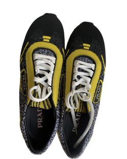 These black and yellow suede sneaker feature a round toe, a lace-up front fastening, a flat rubber sole and a logo to the outside.
