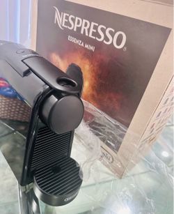 NESPRESSO ESSENZA MINI COFFEE MACHINE WITH GLASS CAPSULE HOLDER BASE.