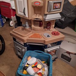 Little Tikes Kid's Kitchen with a set of plastic foods