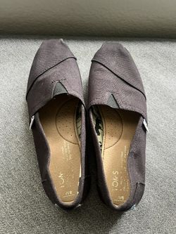Black Toms slip ons