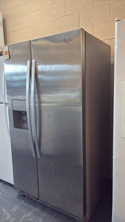 Like new Whirlpool stainless steel side by side refrigerator