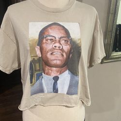 beige graphic crop top t-shirt featuring a portrait of Malcolm X.  