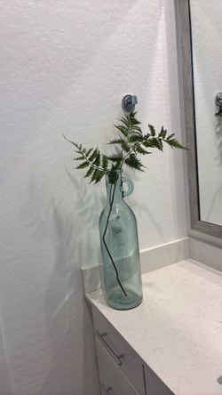 Tall, heavy vase with greenery