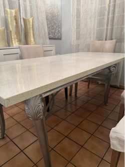 Elegant Dining Table with Stone Top and Ornate Legs