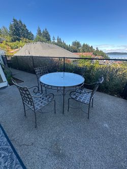 Patio table with glass top and 4 chairs