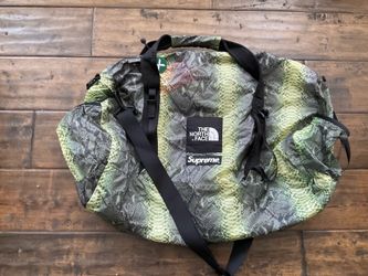 Rare Supreme x The North Face Flyweight Duffel Bag in green snakeskin print.
