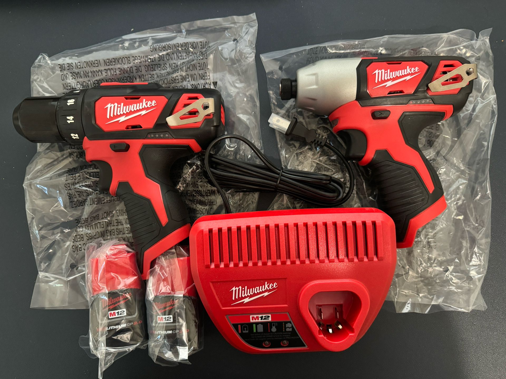 Milwaukee M12 Drill And Impact Driver 2 Batteries And Charger 