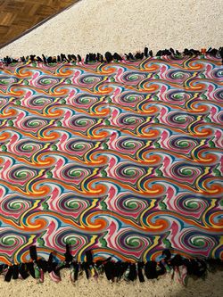 PSYCHADELIC PATTERN ON ONE SIDE AND on FRINGE AND BLACK ON OTHER SIDE. HANDMADE AND NEVER USED.