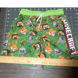 Minecraft kids swim/board shorts — Size 7 (kids). Bright licensed print, elastic waistband with drawstring, mesh lining. Excellent condition — no stai