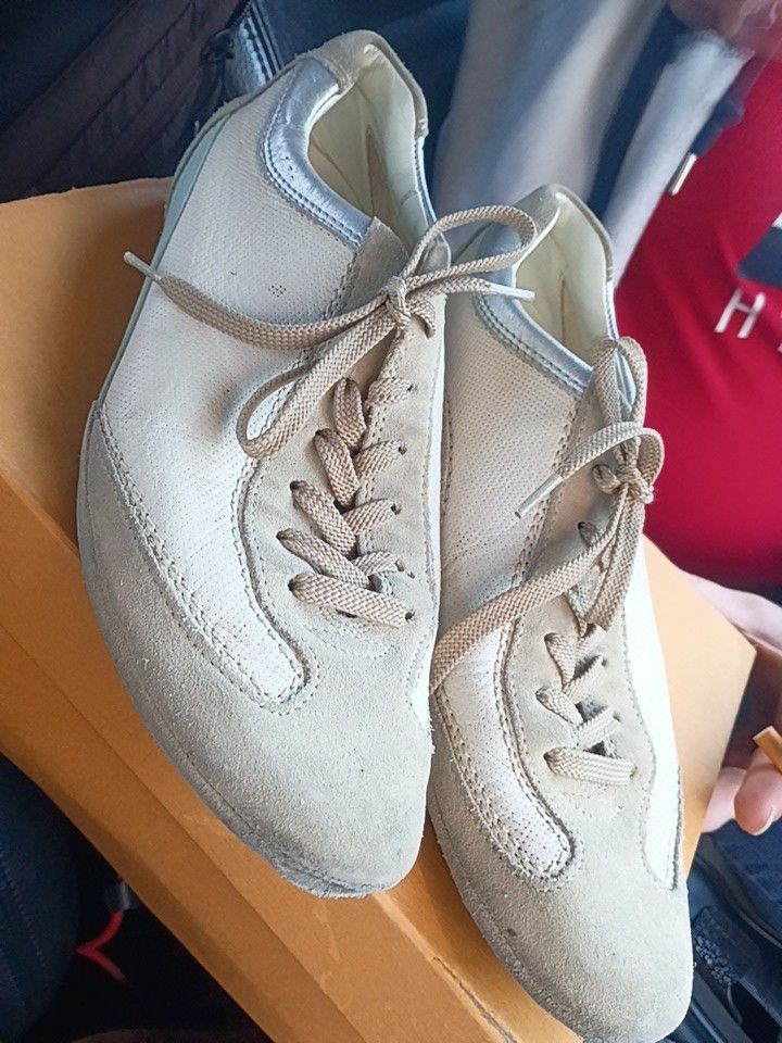 This is a pair of Tod's men's sneakers in cream/tan suede and leather. 