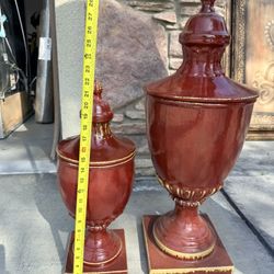 oxblood red porcelain lidded mantel urns or trophy vases. 