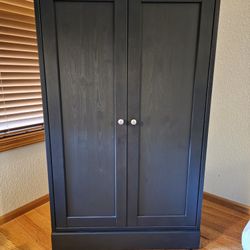 Tall black Ikea Havsta storage cabinet