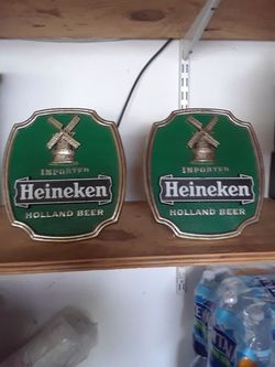 Two Heineken beer signs