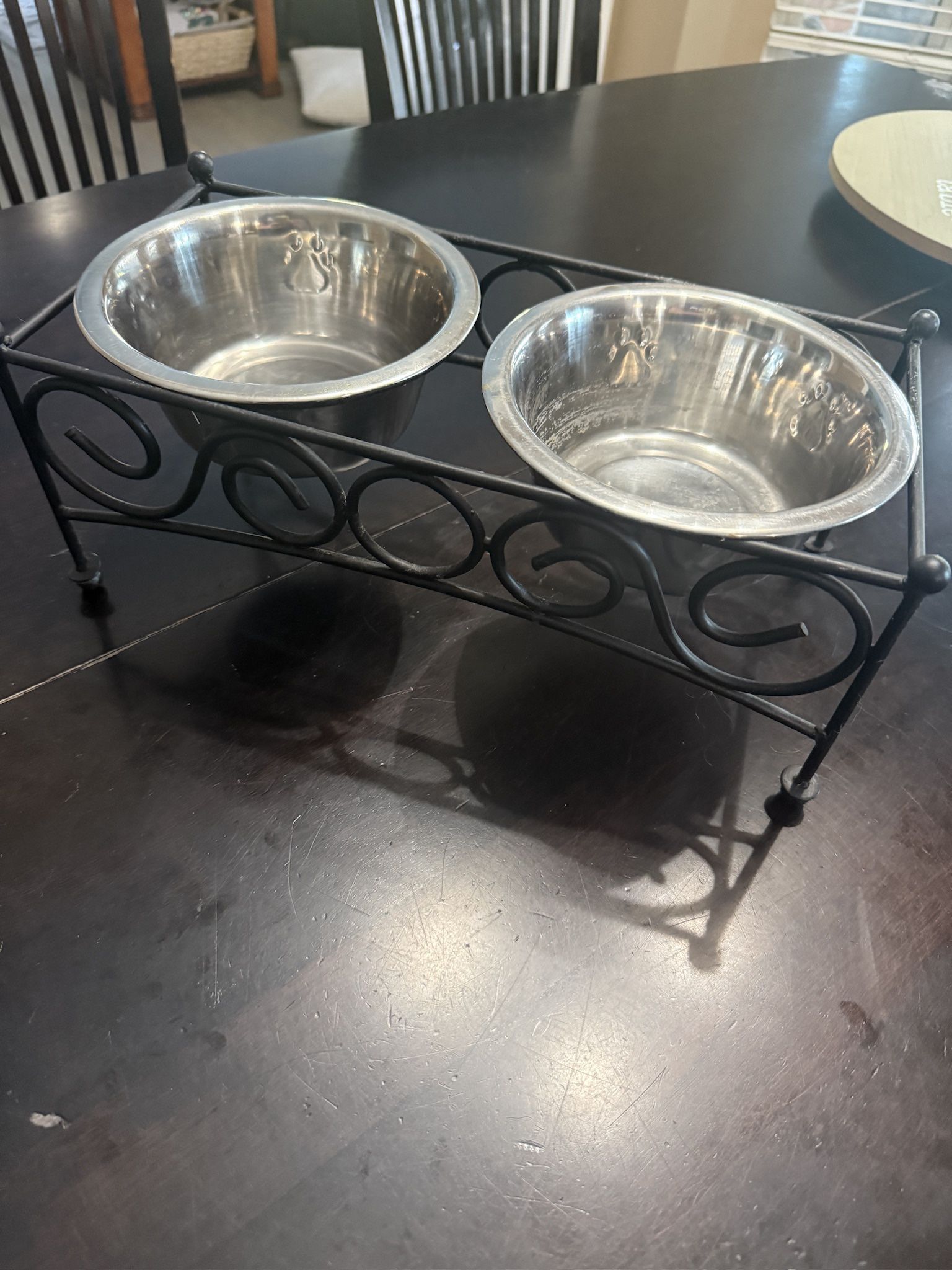 Two Small Elevated Dog Bowls with Black Stand! Bowls have paw prints.