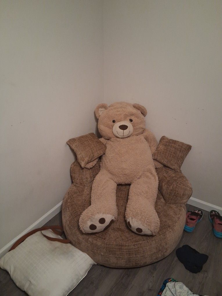 A Big Teddy 4 Pairs Of Boots A Couch