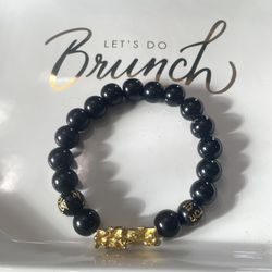 A Feng Shui obsidian, gold Pixiu, mantra bracelet for prosperity. 