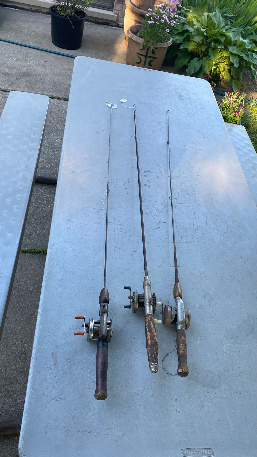 3 fishing poles and reels