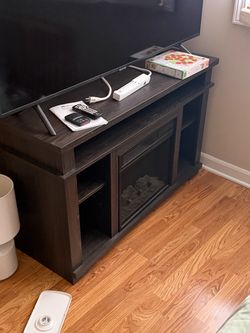 Tv stand with fake fireplace heater.