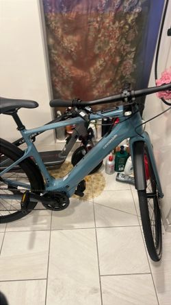 Like NEW Cannondale Tesoro Neo Carbon 2 electric bike features a distinctive blue-grey "Storm Cloud" finish and a lightweight carbon frame ($800.00) c