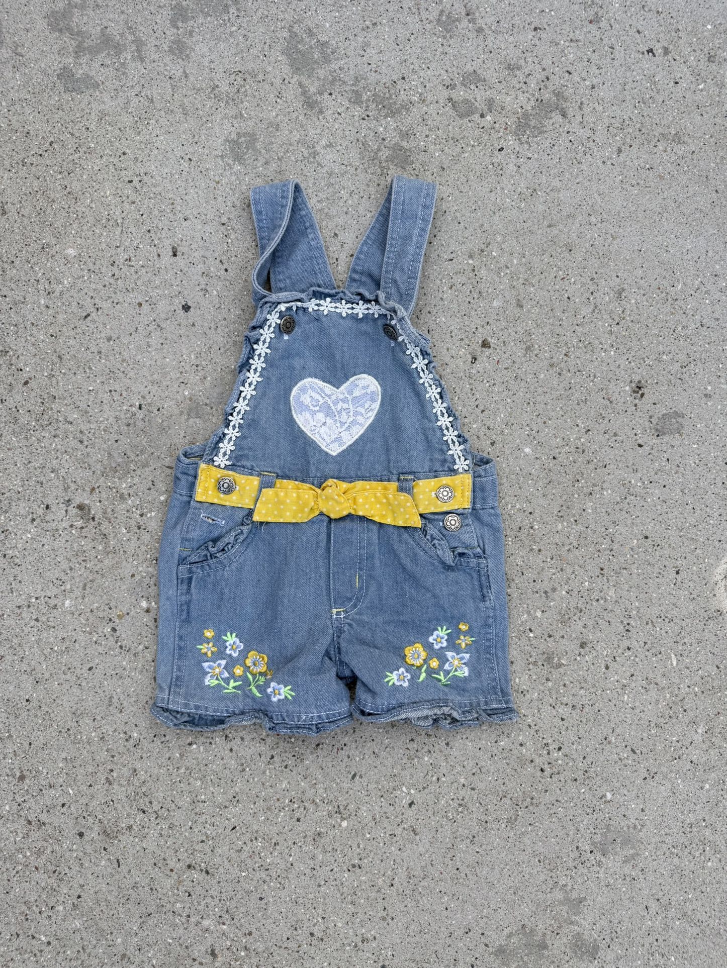 Blue denim overalls with embroidered heart, yellow ribbon, and daisy details size 3T