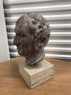 Antique head in concrete