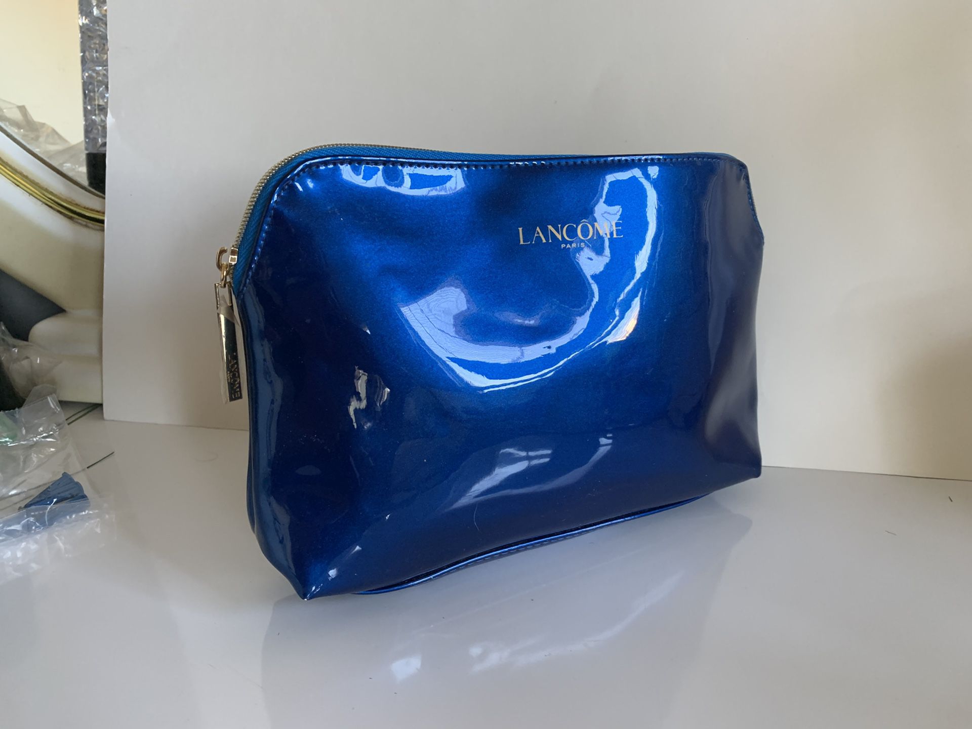 Lancôme cosmetic makeup shiny blue bag. Gold color zipper and handle. Shipped with USPS First Class.
