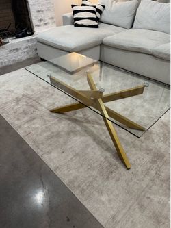 Glass coffee table with brushed gold base