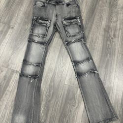 Grey washed distressed stacked jeans