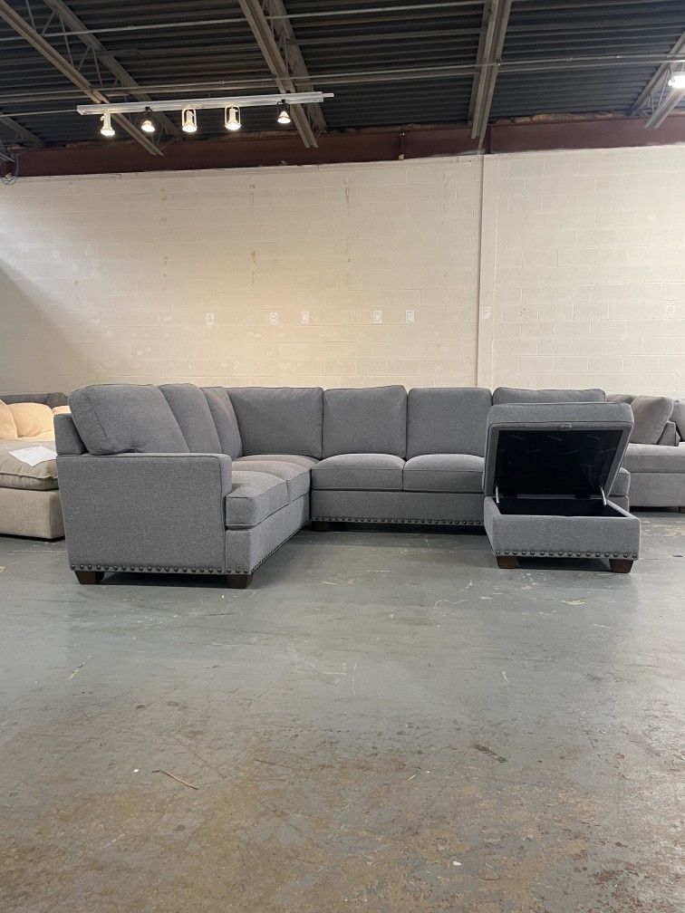 Gray sectional couch with storage ottoman