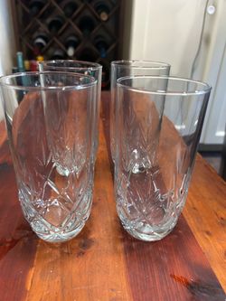 Set of 4 clear pressed glass highball tumblers with a decorative geometric cut-style pattern and heavy base.  Classic tall glasses, great for water, i