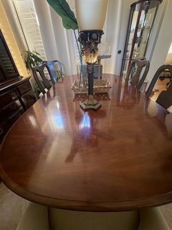 Large cherry wood table expandable with folding toppers and 6 chairs