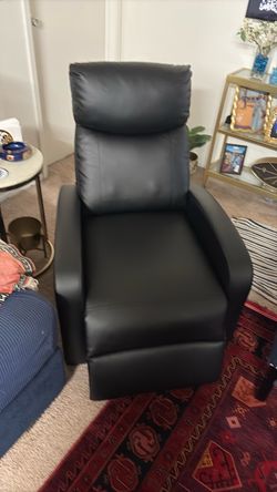 A comfortable leather chair featuring a leg rest that extends automatically as soon as you sit on it.