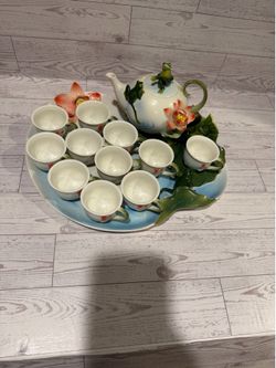 Whimsical tea set with frog and lily pad motifs