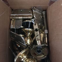 Box of brass door knobs and hinges